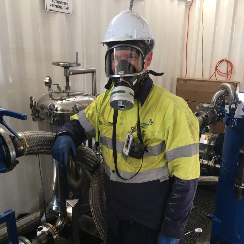 BioKem Staff conducting hot oil flushing in full PPE on a hydrocarbon compressor